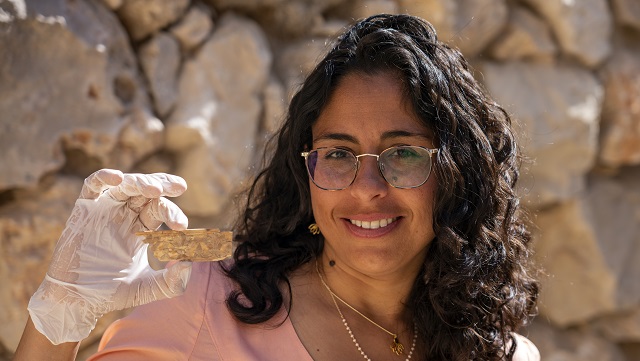 Reli-Avisar-from-Tel-Aviv-University-with-an-ivory-plaque-adorned-with-a-lotus-flower.-Yaniv-Berman-Israel-Antiquities-Authority.jpg
