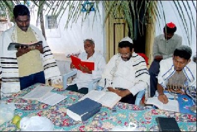 At prayer in the sukkah.jpg